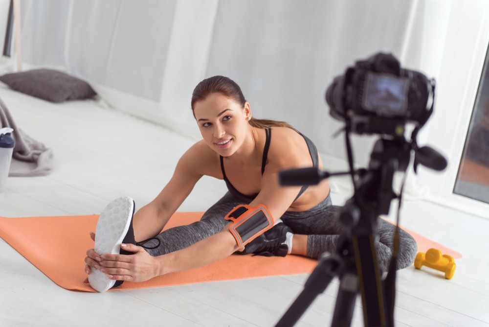 woman fitness blogger taking photos for her blog website