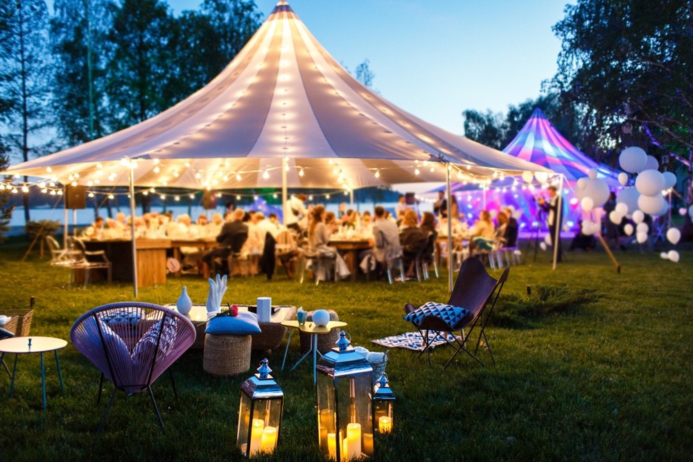 colorful tents with wedding guests and lights