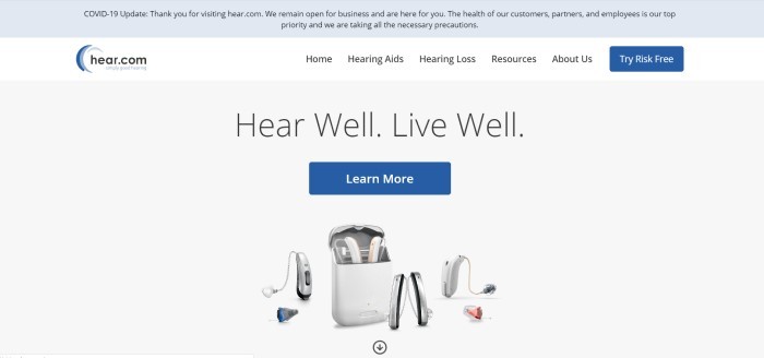 This screenshot of the home page for Hear.com is a gray header, a white navigation bar, and a light gray main section with black text, a blue call to action button, and a photo showing several pairs of hearing aids.