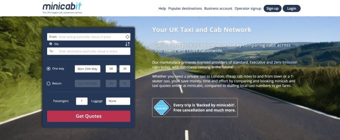 This screenshot of the home page for Minicabit has a blurry photo of a country road winding through a green landscape with a blue sky, behind a dark blue and white search section with a red call to action button on the left side and white text on the right side.