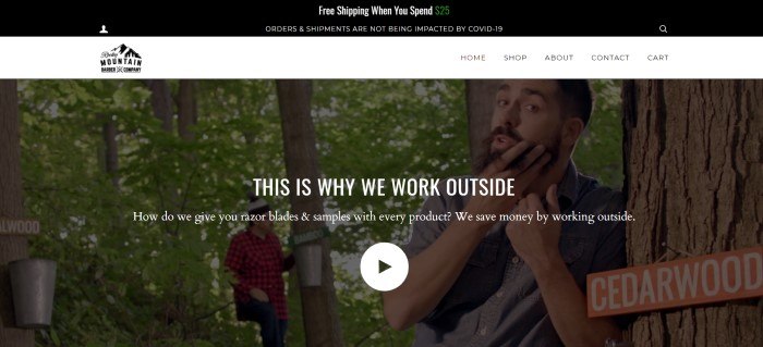 This screenshot of the home page for Rocky Mountain Barber Company has a black and white header and navigation bar above a dark filtered video shot of two men with beards working outside in a wooded area, along with white text announcing free razor blades and samples.