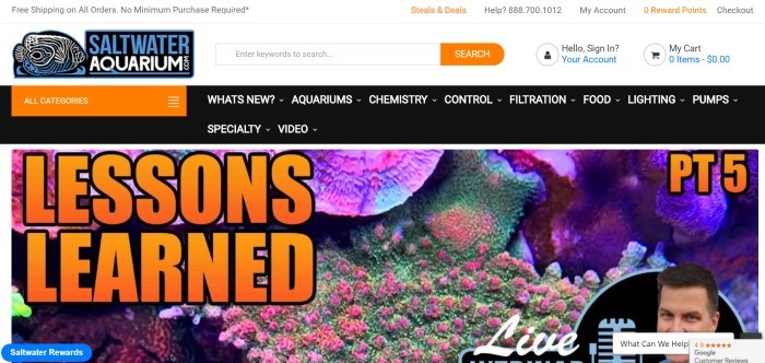 This screenshot of the home page for SaltwaterAquarium.com has a white search bar above a black navigation bar with an orange drop-down category menu, which is above a large photo showing the inside of an aquarium behind orange text and a blue call-to-action button.