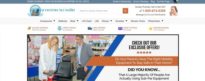 This screenshot of the home page for Scooters N' Chairs has a light blue announcement bar, a white search bar, a gray navigation bar, and a white main section with a photo showing a smiling blonde woman in a white shirt and a smiling gray-haired man in a blue collared shirt with a gray jacket looking at a black mobility scooter together and a white text section with black text inviting customers to check out exclusive offers.