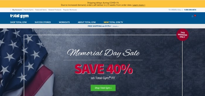 This screenshot of the home page for Total Gym has a yellow, gray, and blue navigation bar and header section above a blue background with a photo of an American flag, as well as white and red text announcing a Memorial Day sale and a green call to action button.