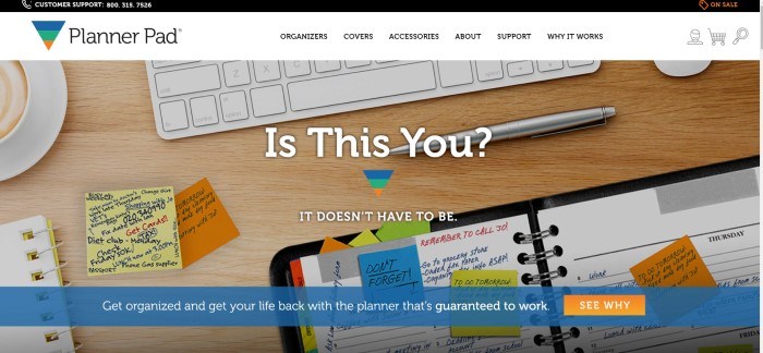 This screenshot of the home page for Planner Pad has a black customer support bar, a white navigation bar, and an overhead photo showing a keyboard, a cup of coffee, a pen, and various handwritten papers, sticky notes, and notebooks lying on a wooden desk, behind white text and a blue and orange call to action button.