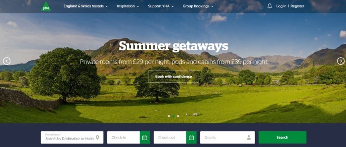 This screenshot of the home page for YHA has a dark blue header with white text above a photo of a green countryside, along with more white text and a transparent call to action button with a white outline and white text, as well as a dark gray search bar at the bottom of the page.