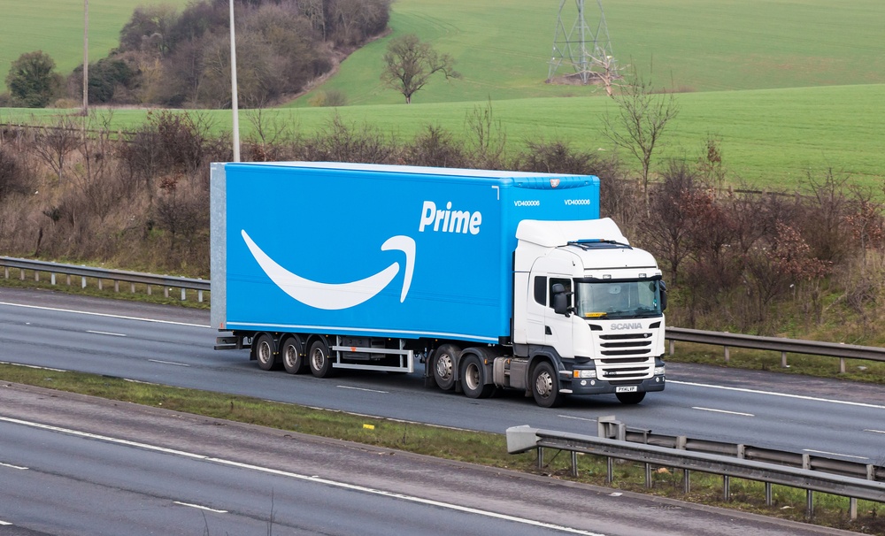 amazon prime delivery truck with blue box and white vehicle