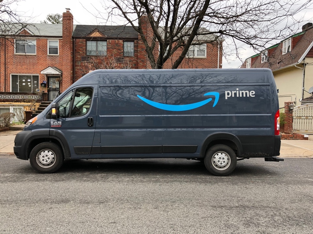 amazon prime delivery van in front of brick houses