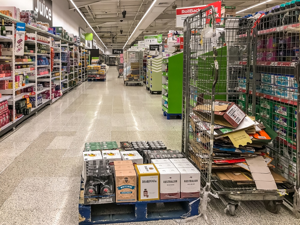 grocery store shelves being stocked at night