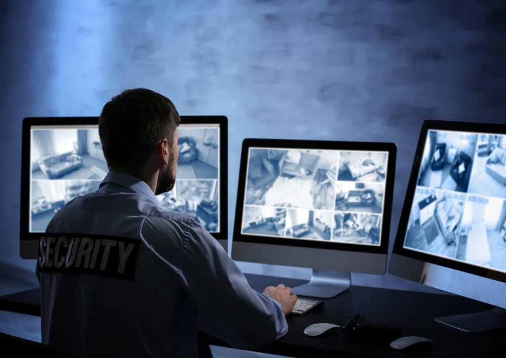 night time security guard watching cameras