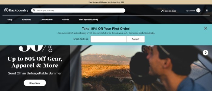 This screenshot of the home page for Backcountry has a tan header, a black search bar and navigation bar with white text, a black and white ad section on the left side of the page, a photo of a smiling man looking out of a vehicle window over desert scenery on the right side of the page, and an aqua opt-in window for getting a discount on the first order.