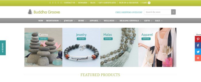 This screenshot of the home page of Buddha Groove has a green header, a white search bar, a gray navigation bar, and a white main section with product photos, including cairns, jewelry, beaded malas, and apparel (including a pink tank top).