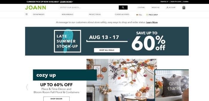 This screenshot of the home page for JoAnn has a black header, a white navigation bar and main page background, a green JoAnn logo, a dark green section with white text announcing a sale, and a row of photos showing fall-themed home décor.