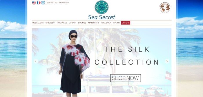 This screenshot of the home page for Sea Secret has an ocean scene for a background behind a white main section with an aqua-colored logo, a white navigation bar, and a photo of a mannequin in a black coverup with a pink floral print, as well as black text announcing a fashion collection.