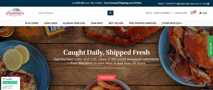 This screenshot of the home page for Cameron's Seafood has a dark blue header, a white search bar and navigation bar, and a large overhead photo showing crab legs on blue plates on a wooden table, along with white text and a red call to action button.