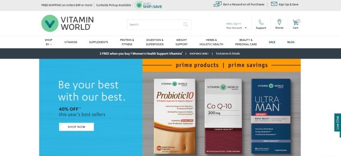 This screenshot of the home page for Vitamin World has a gray header, a white navigation bar with black text and a green logo, a black announcement bar, a blue text section on the left side of the page with white and black text and a white call to action button on the left side of the page, and a photo showing three supplement products in boxes with the Vitamin World logo on them on the right side of the page, along with an orange sales bar.