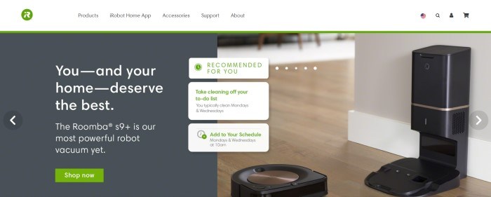 This screenshot of the home page for iRobot has a white navigation bar with a green logo above a main section with a gray background, white text, and a green call to action button on the left side of the page and photo of wooden floors and a robot cleaner on the right side of the page, with three white text boxes containing green text overlapping the main sections in the center of the page.