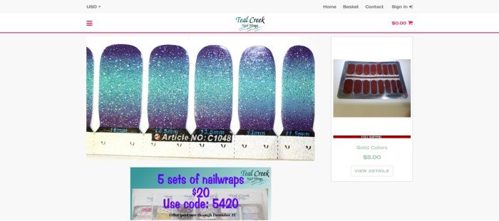 This screenshot of the home page for Teal Creek Nail Wraps has a gray header and navigation bar with red elements above a closeup photo showing blue sparkly nail wraps in the center and left side of the page, a package of orange solid wraps on the right side of the page, and a sales announcement box in teal with a photo of several products and blue text at the bottom of the page.