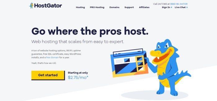 This screenshot of the home page for HostGator as a pale gray background, black text throughout the page, and graphic elements that include a blue and orange alligator holding a laptop, along with an orange call to action button.