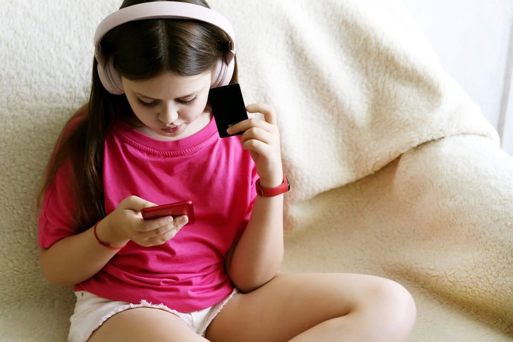 young gen z girl using credit card to shop online with mobile phone