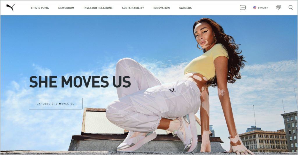 screenshot of PUMA homepage, with a picture of a woman posing with Puma sneakers for main image