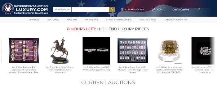 This screenshot of the home page for Auction King has a blue header with a flag fading into it and a search bar across the top, a white navigation bar, and a white main section with red and black text and a row of photos of high-end items, including figurines, stamps, and rings, to be auctioned.