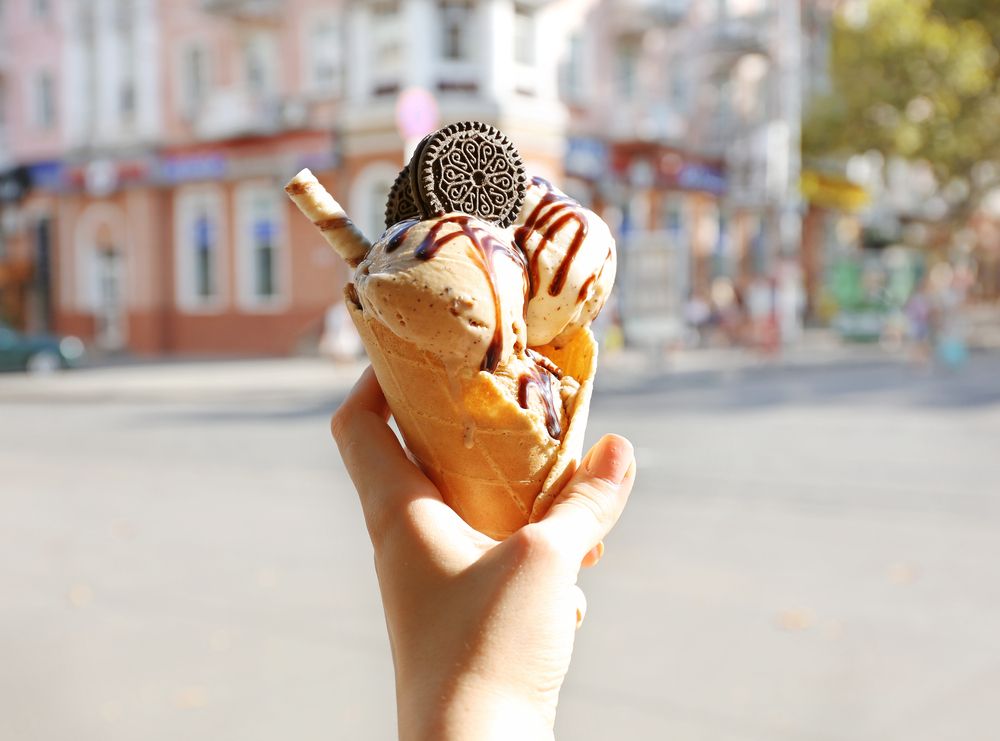 gourmet ice cream cone with oreo topping outdoors