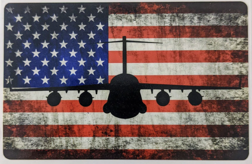 The silhouette of a bomber is superimposed over an American flag background. 