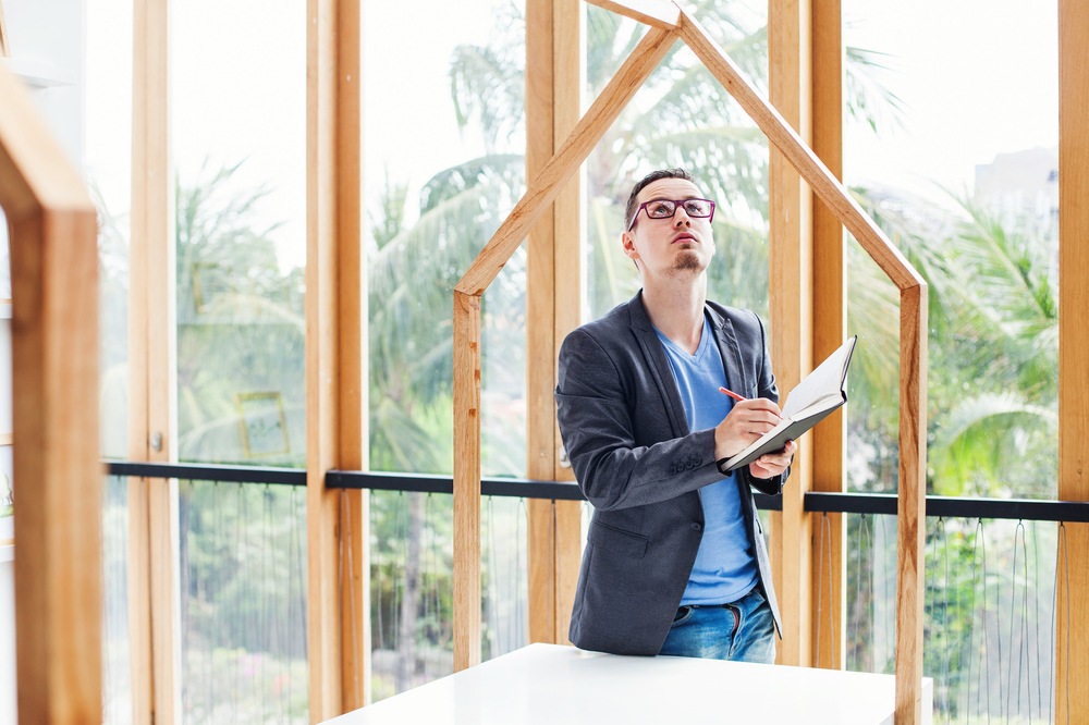 A man inspects the frame of a new home.