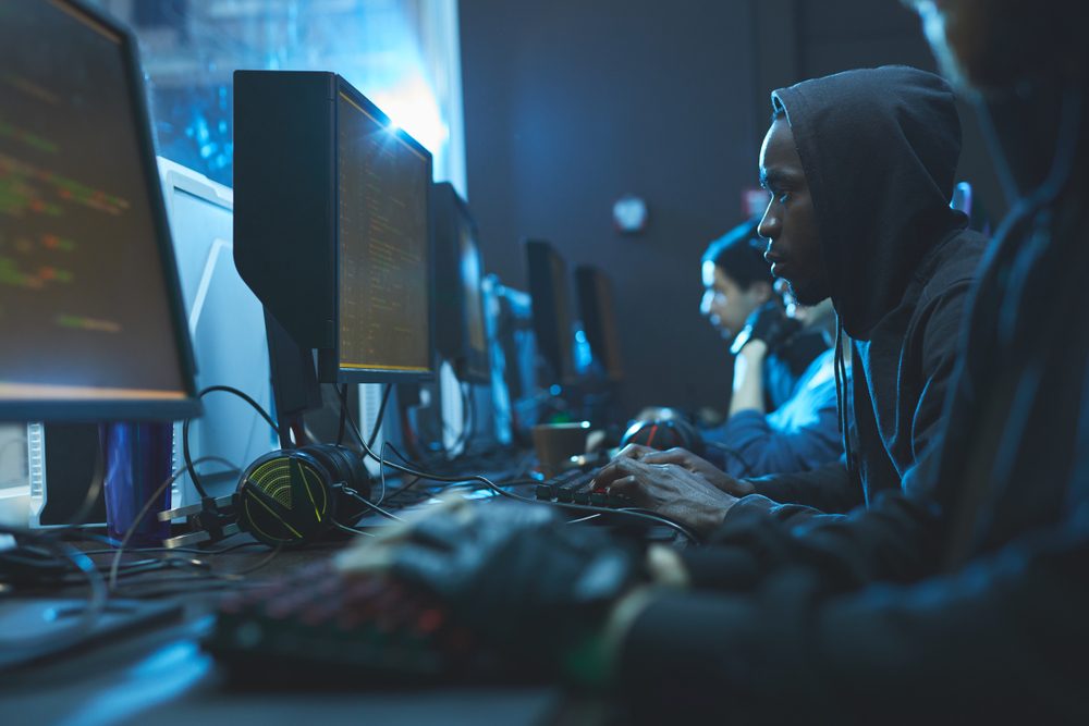 A man stares intently at a computer screen.