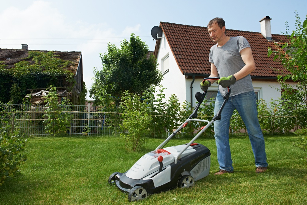 A man mows a lawn.