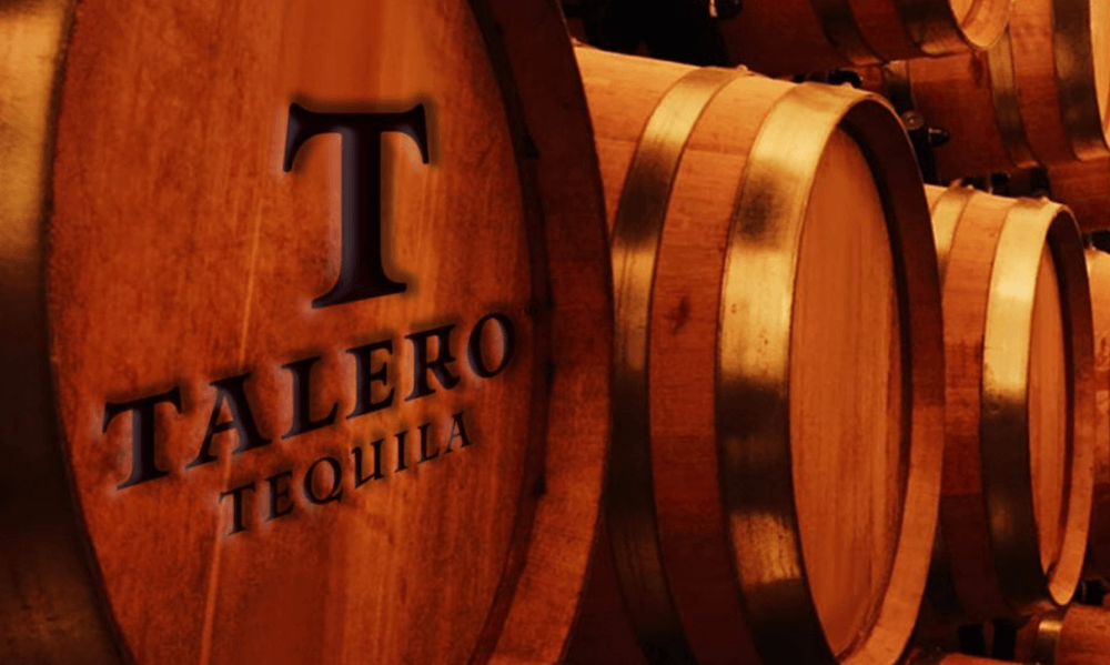 The name Talera Tequila is stamped on wooden barrels.