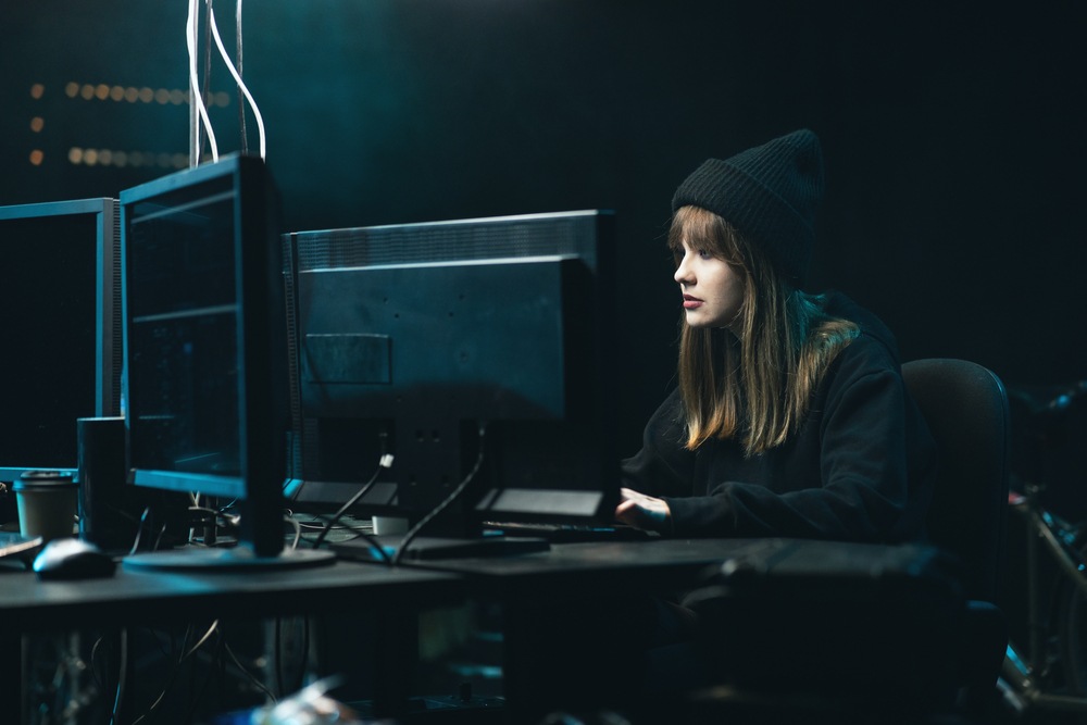 A woman in a black cap hosts a game server from her home.