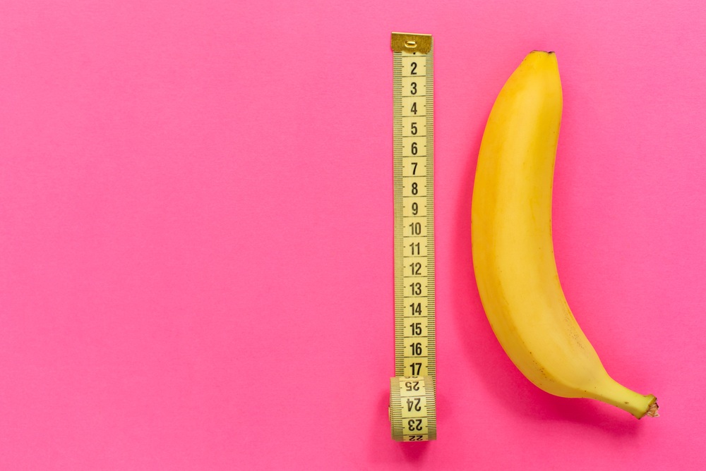 fresh banana on pink background with tape measure. how long should a blog post be?