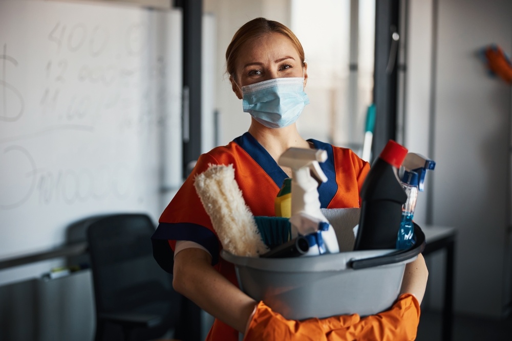 Janitor holding cleaning equipment