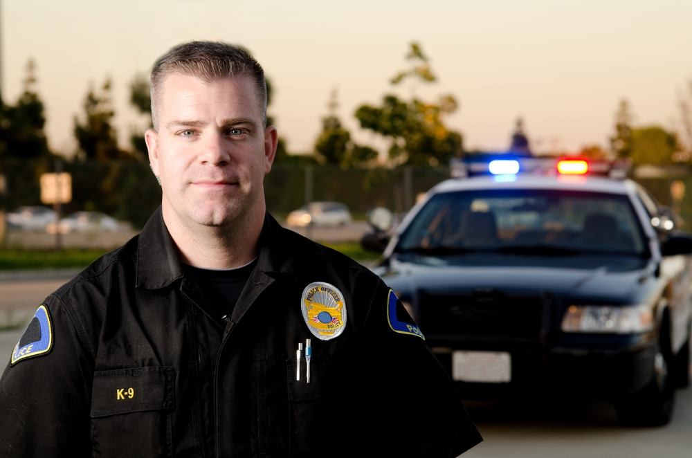 Police officer standing in front of car