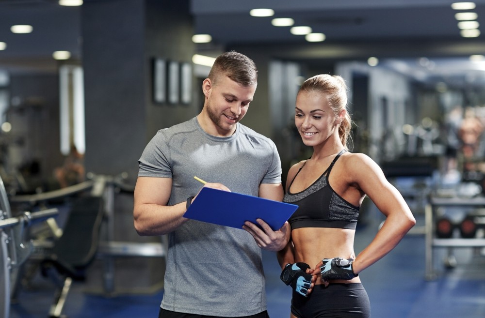 Fitness instructor working with client