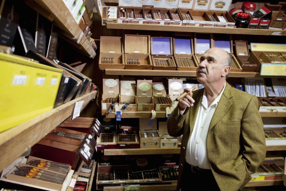 Man examining cigars