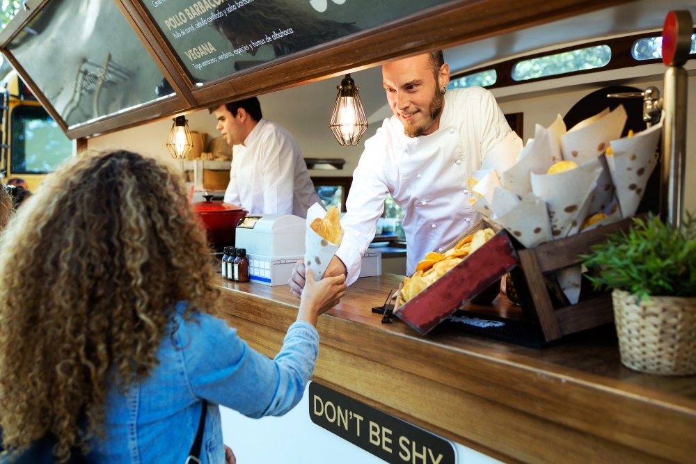 Woman ordering from a food truck